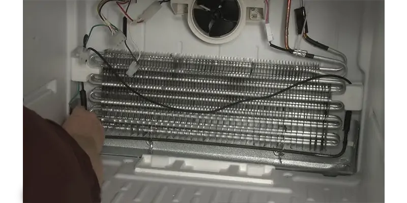 A tubular heater installed along the bottom of a greenhouse wall to protect plants from frost.