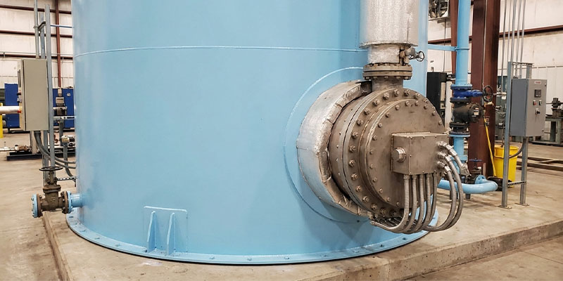 Industrial flange heater installed in a large thermal oil tank