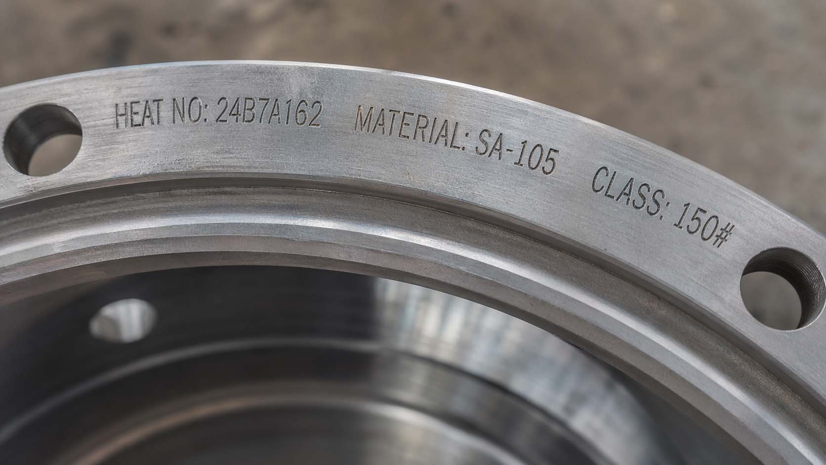 Close-up showing how to find heat number on flanges for industrial heating systems.