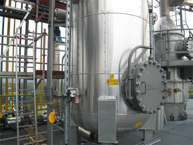 Industrial chemical tank heater system with flange immersion heater installed in a chemical processing storage tank